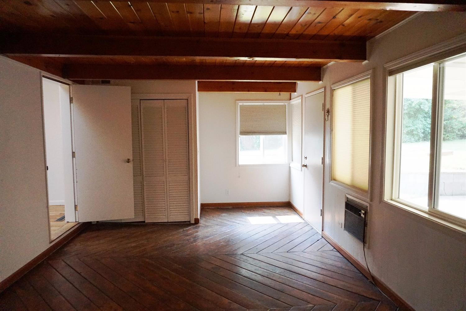 1312 Talent Avenue Talent, OR 97540 - Photo 8 of 21 a view of an empty room with wooden floor and a window