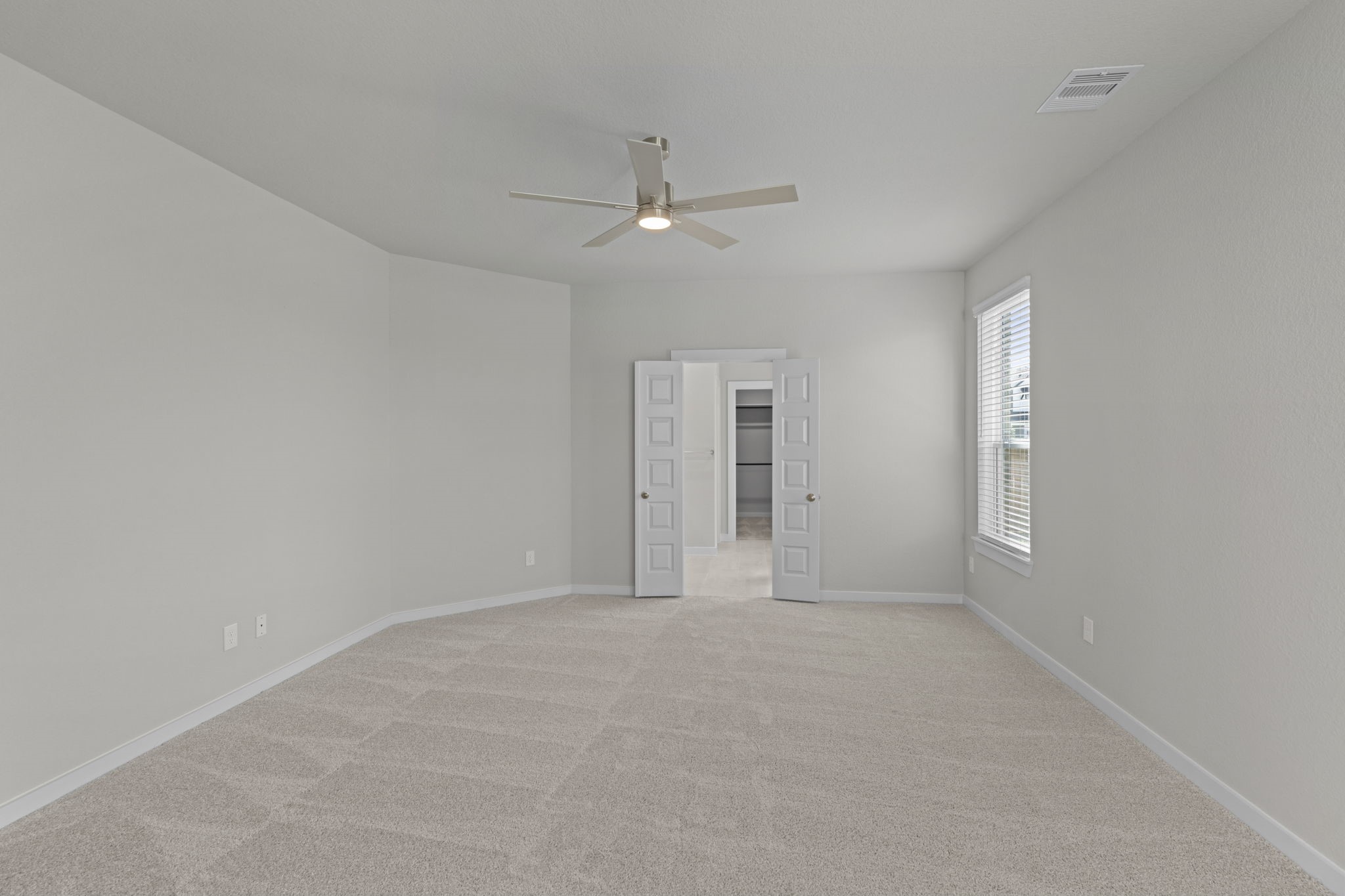 3102 Boulder Ridge Drive Rosenberg, TX 77471 - Photo 24 of 47 an empty room with chandelier fan and windows