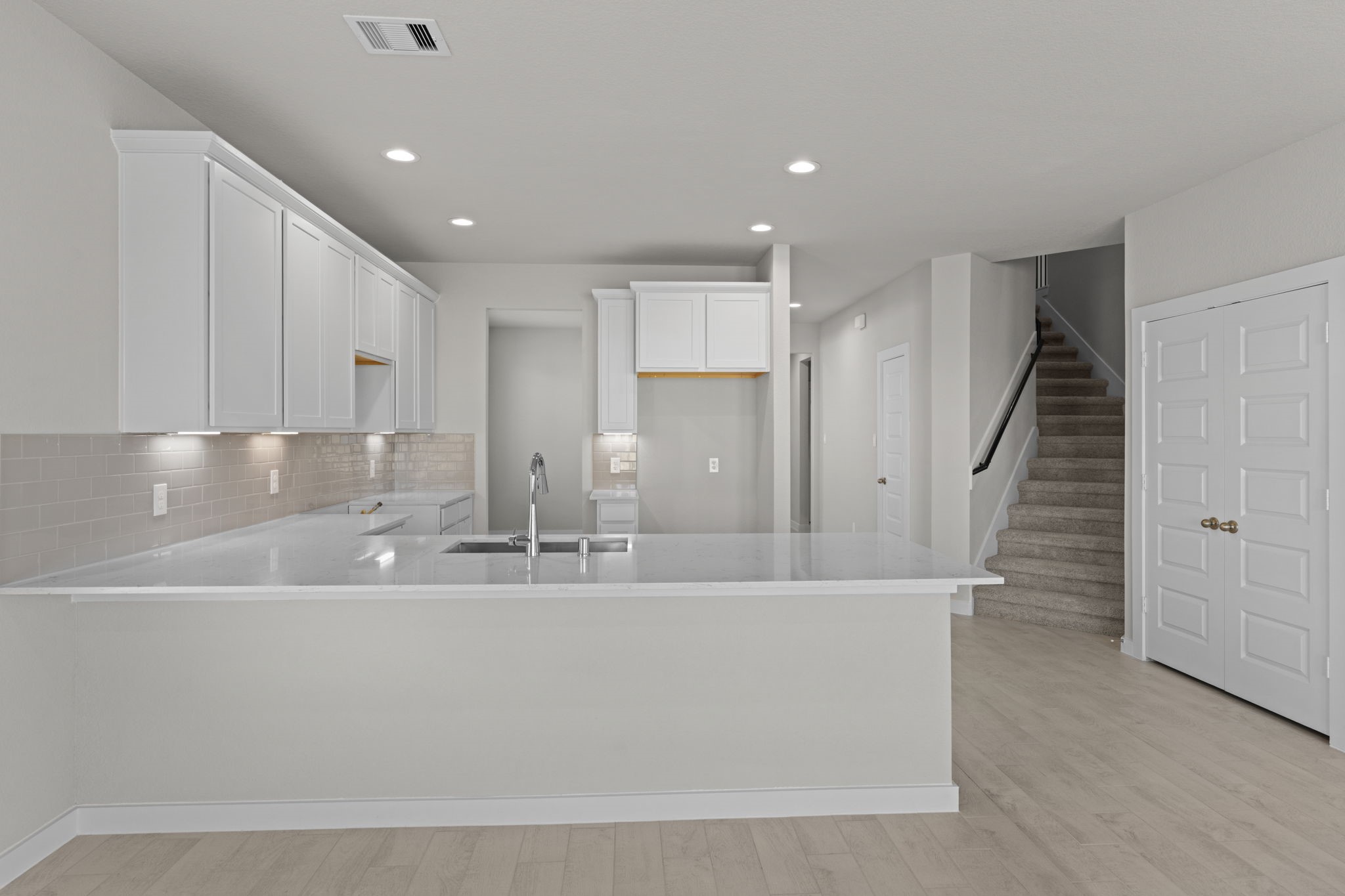 3102 Boulder Ridge Drive Rosenberg, TX 77471 - Photo 5 of 47 a view of kitchen with center island stainless steel appliances wooden floor and living room view