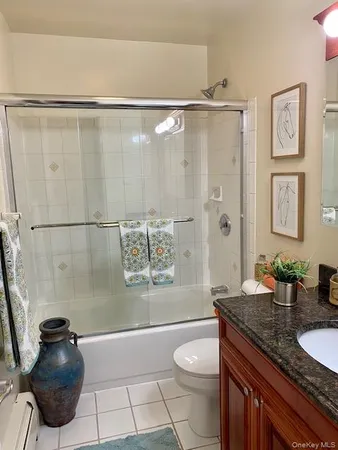 a spacious bathroom with a granite countertop sink a toilet a mirror and shower