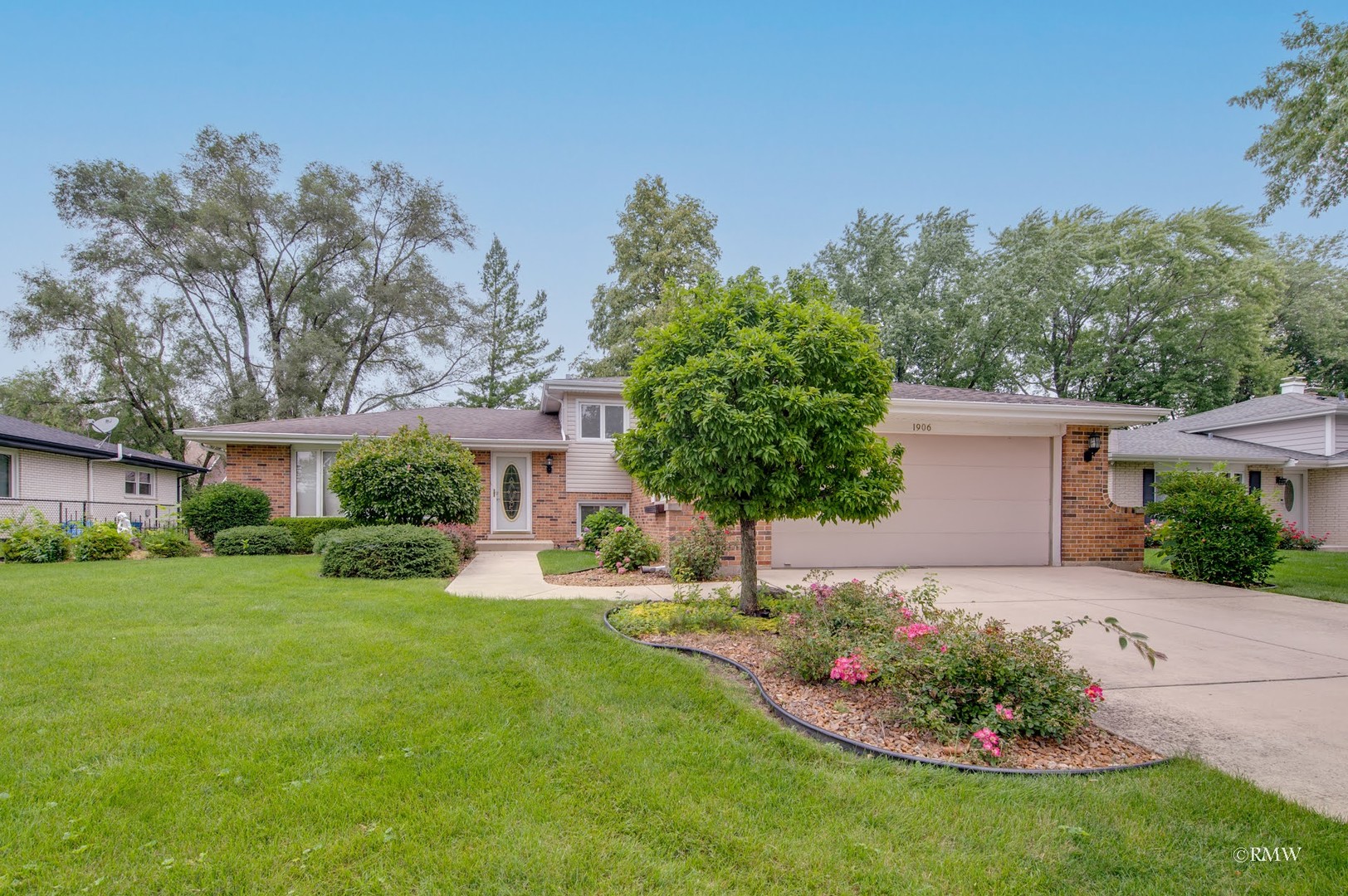 1906 McAdam Road Darien, IL 60561 - Photo 1 of 32 a front view of a house with a yard and trees