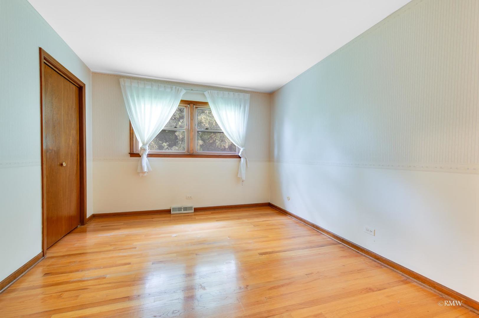 1906 McAdam Road Darien, IL 60561 - Photo 11 of 32 a view of empty room with wooden floor and fan