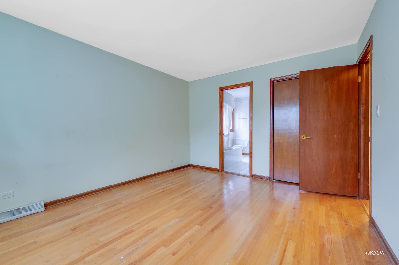 1906 McAdam Road Darien, IL 60561 - Photo 12 of 32 a view of an empty room with wooden floor and a window