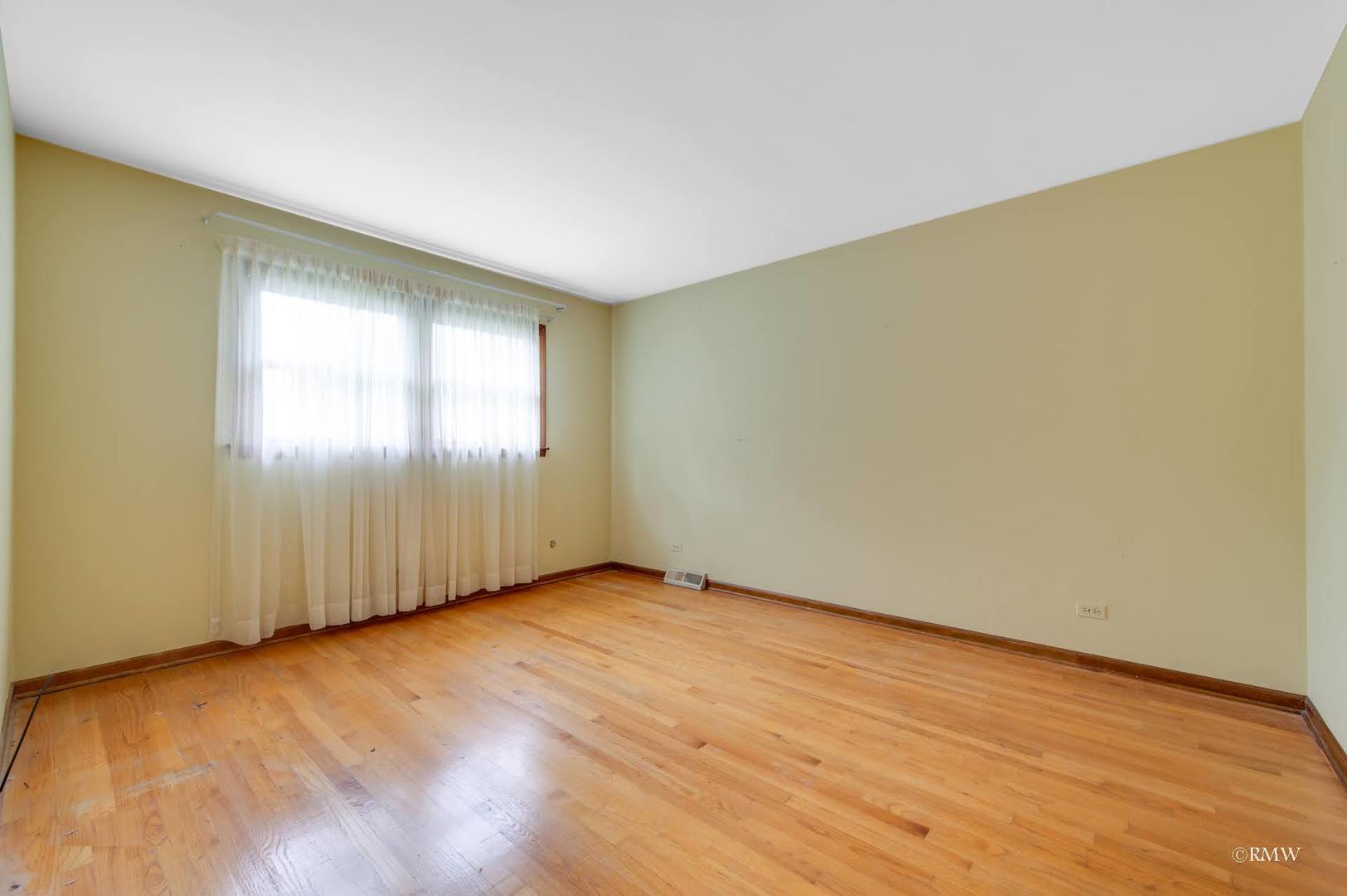 1906 McAdam Road Darien, IL 60561 - Photo 13 of 32 an empty room with wooden floor and windows