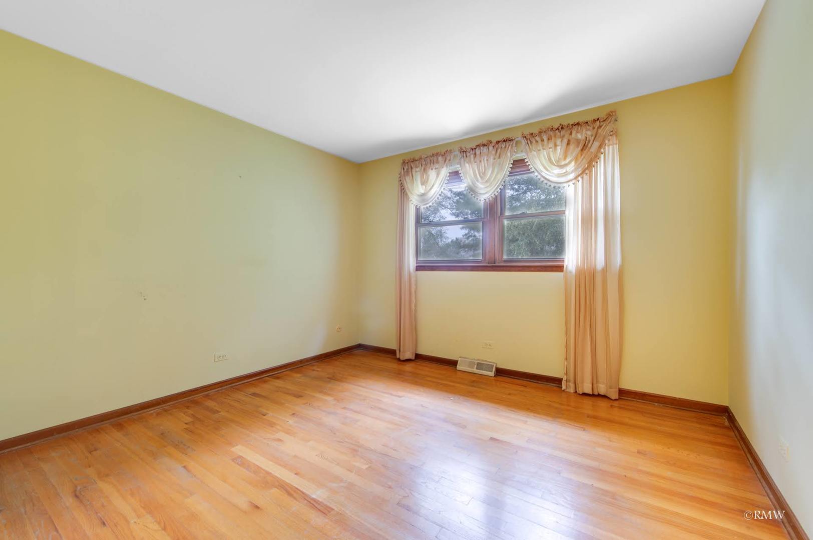 1906 McAdam Road Darien, IL 60561 - Photo 14 of 32 an empty room with wooden floor and windows