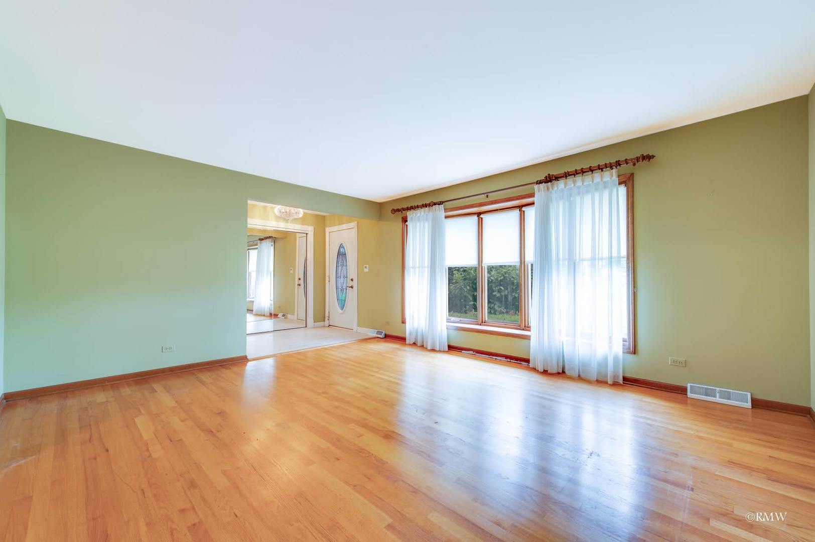 1906 McAdam Road Darien, IL 60561 - Photo 15 of 32 a view of an empty room with wooden floor and a window