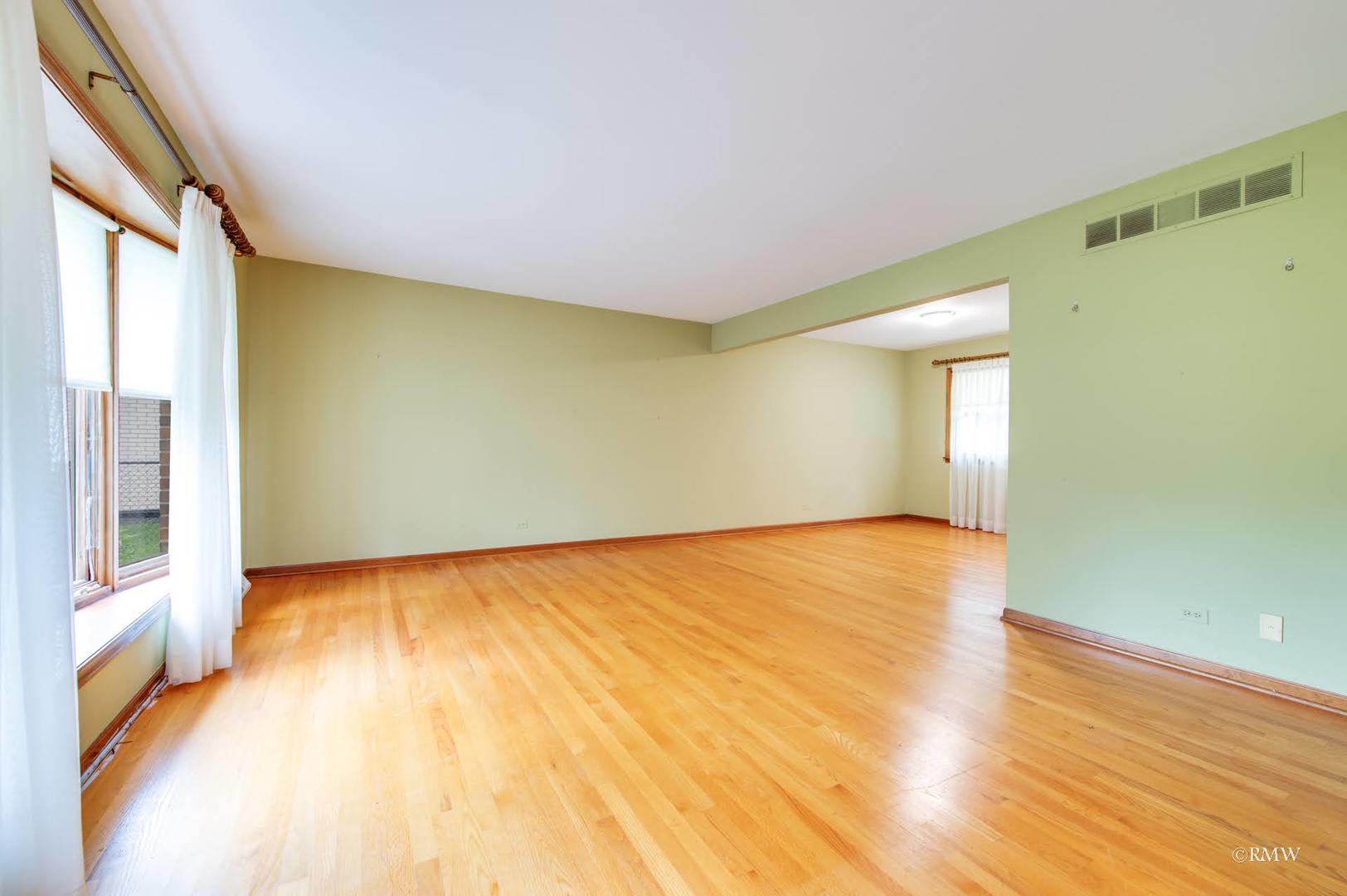 1906 McAdam Road Darien, IL 60561 - Photo 17 of 32 a view of empty room with wooden floor and fan