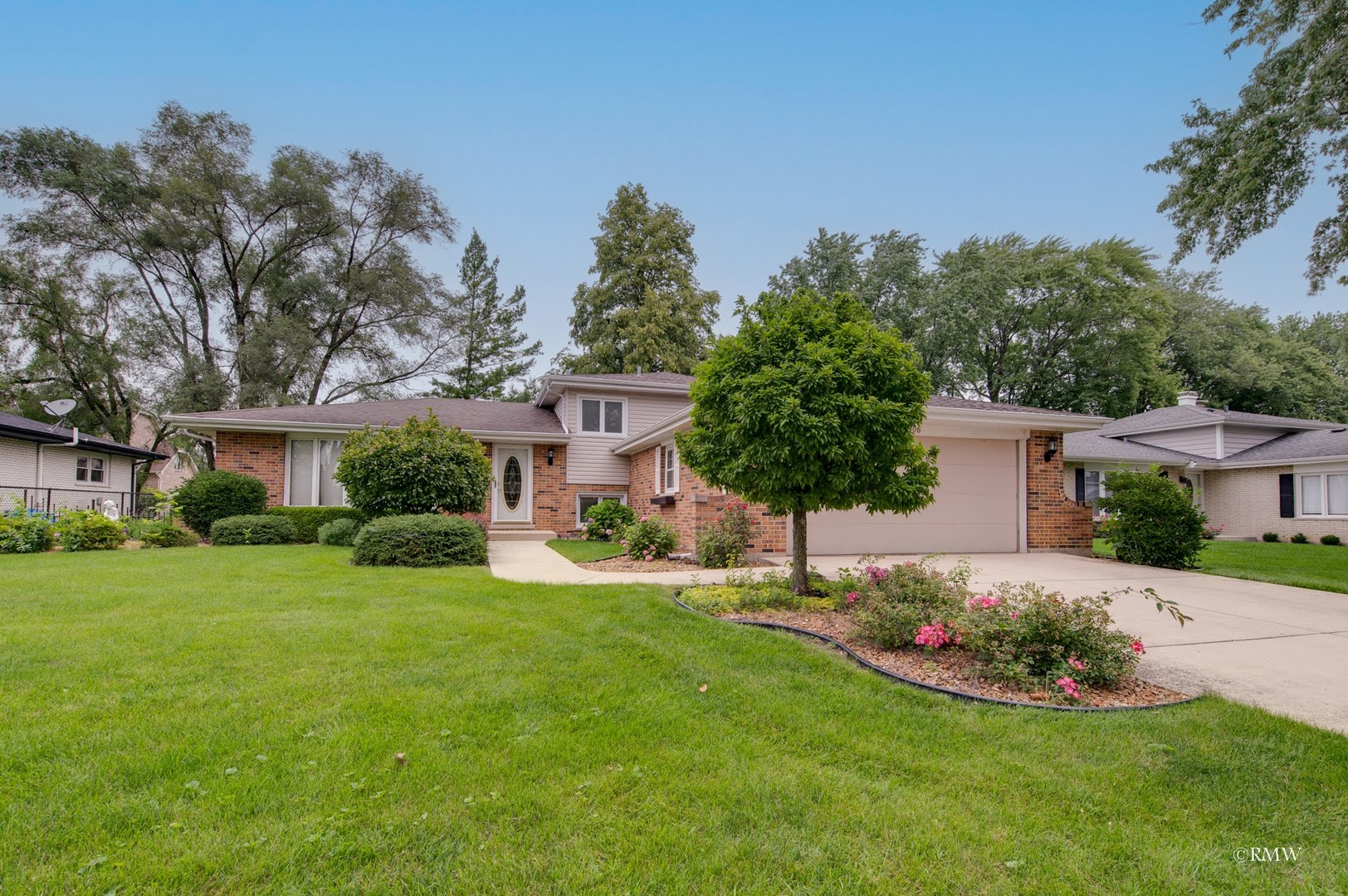 1906 McAdam Road Darien, IL 60561 - Photo 2 of 32 a front view of a house with a yard and trees