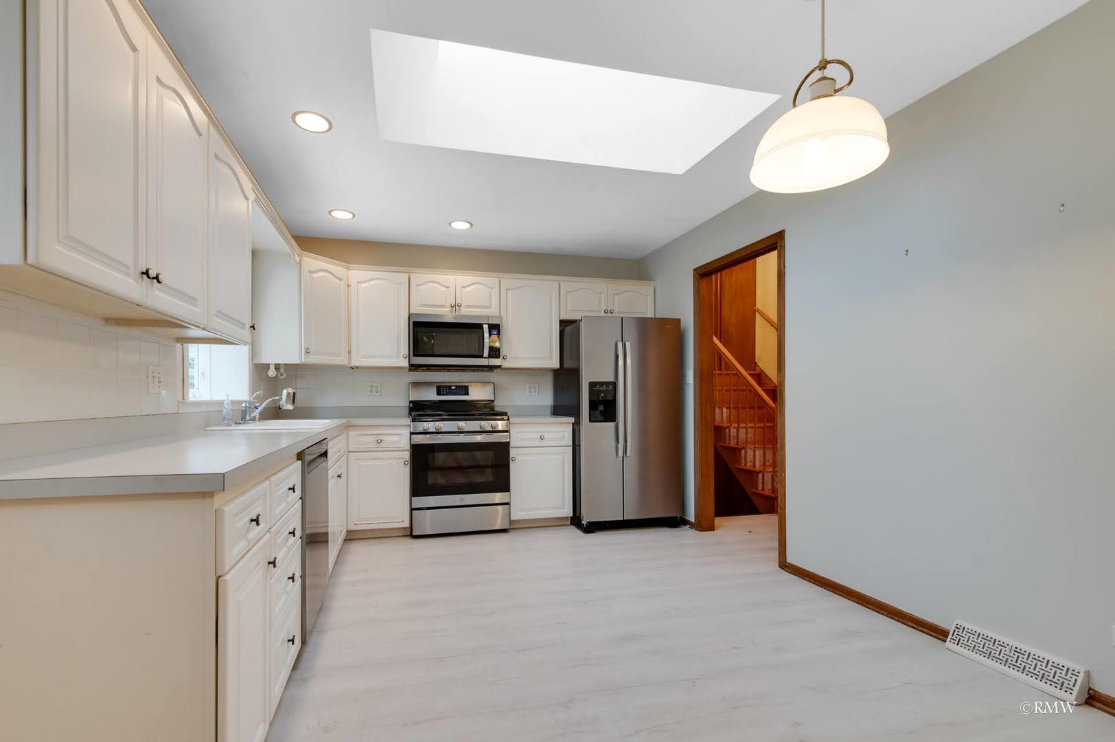 1906 McAdam Road Darien, IL 60561 - Photo 6 of 32 a kitchen with stainless steel appliances a refrigerator sink and cabinets