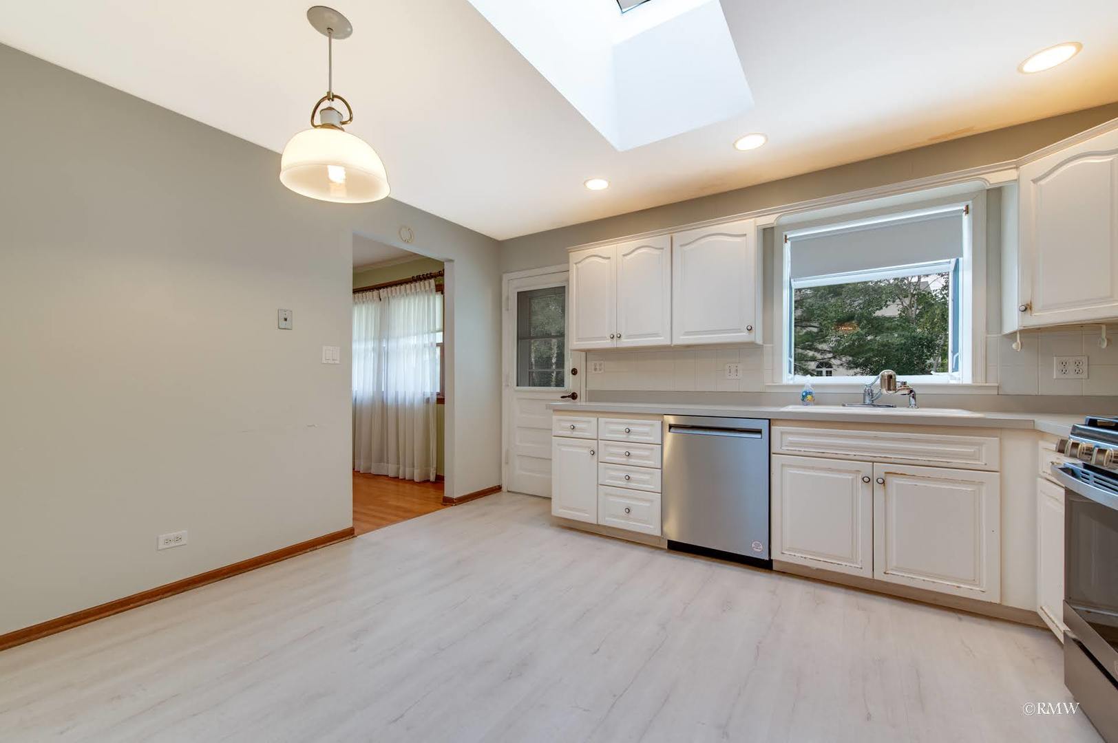 1906 McAdam Road Darien, IL 60561 - Photo 8 of 32 a kitchen with white cabinets and window