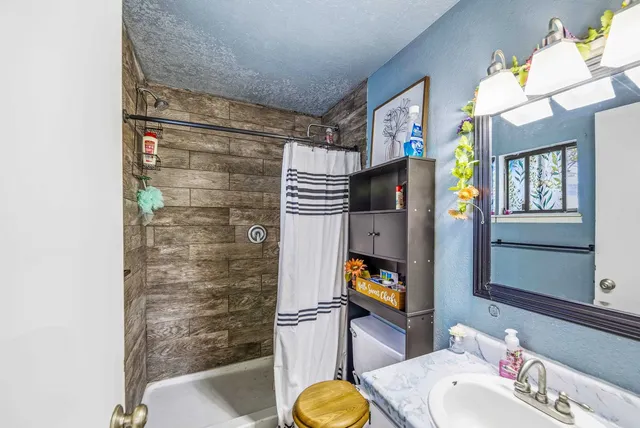 a bathroom with a sink toilet and shower