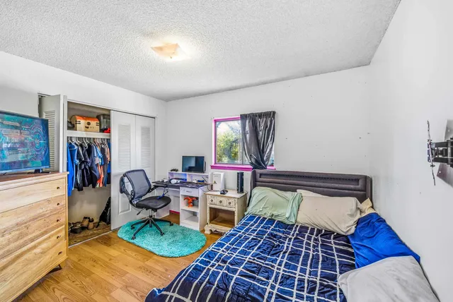 a bedroom with furniture and a rug