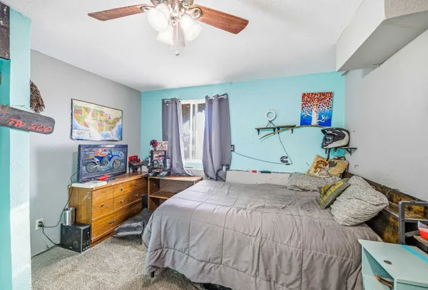 a bedroom with a bed and a chandelier