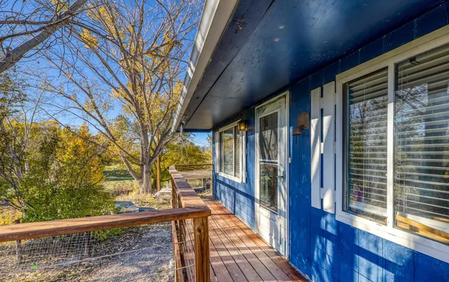 a view of balcony with wooden floor and fence