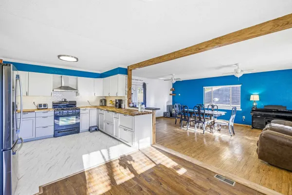 a large kitchen with lots of counter space and furniture