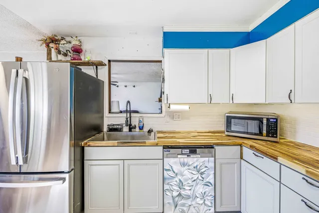 a kitchen with stainless steel appliances granite countertop a refrigerator sink and cabinets