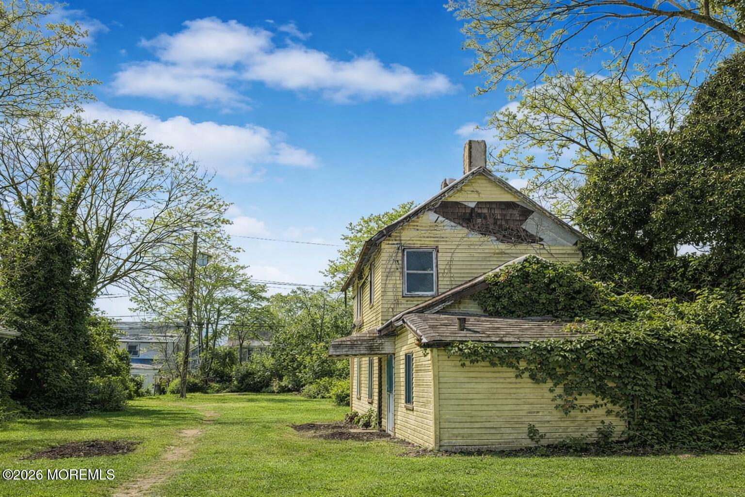 117 Laurel Street Long Branch, NJ 07740 - Photo 4 of 6 a front view of a house with a garden