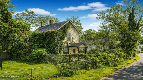 an aerial view of a house with a yard basket ball court and outdoor seating