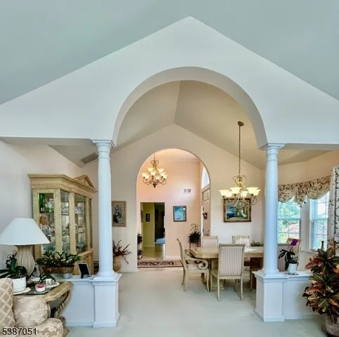 a living room with furniture a fireplace and a large window with garden view