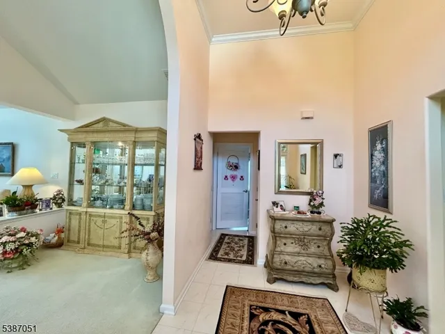 a living room with furniture and a chandelier