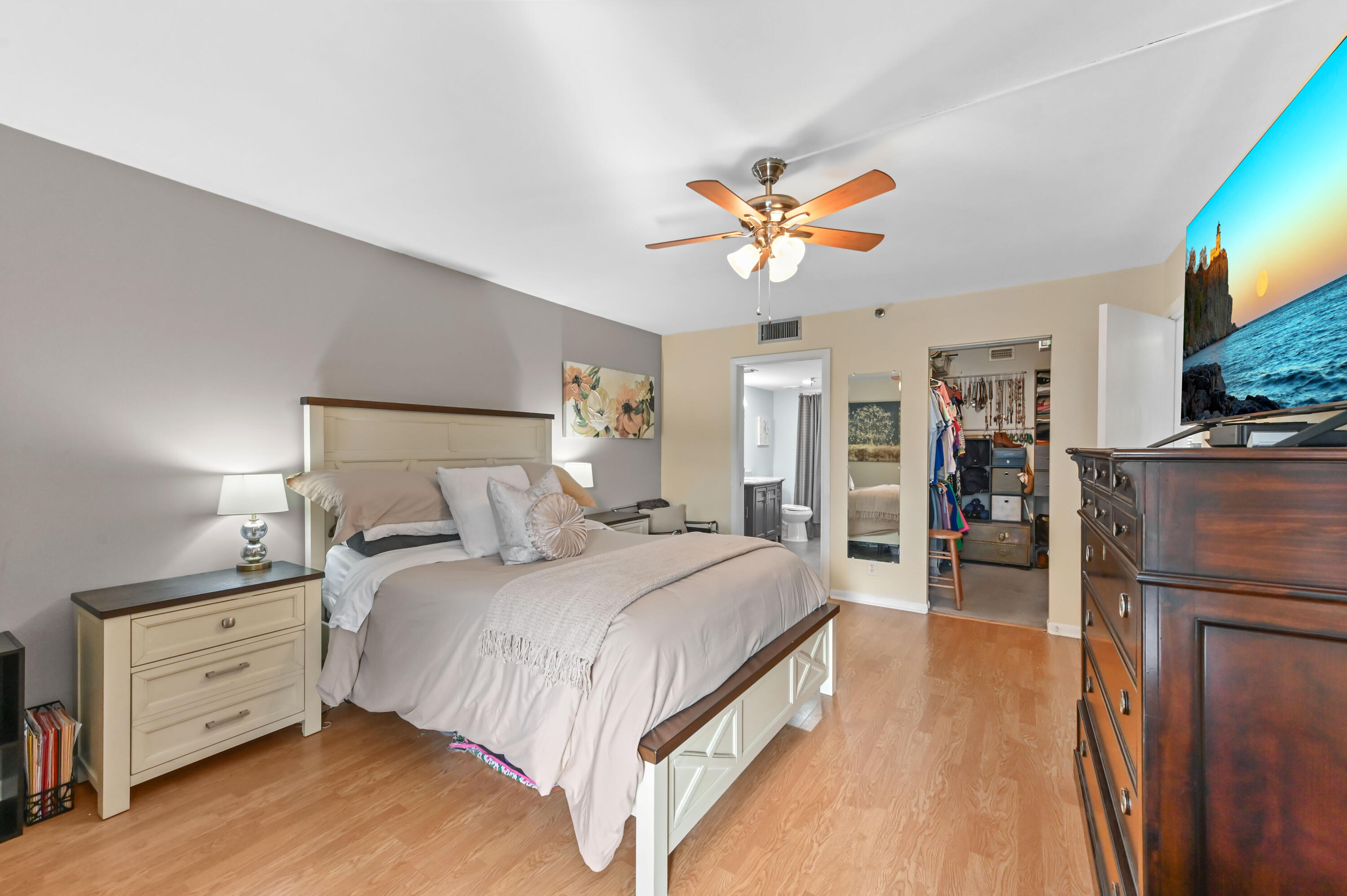 198 Northwest 67th Street, Unit 207 Boca Raton, FL 33487 - Photo 20 of 42 a bedroom with a bed and a chandelier