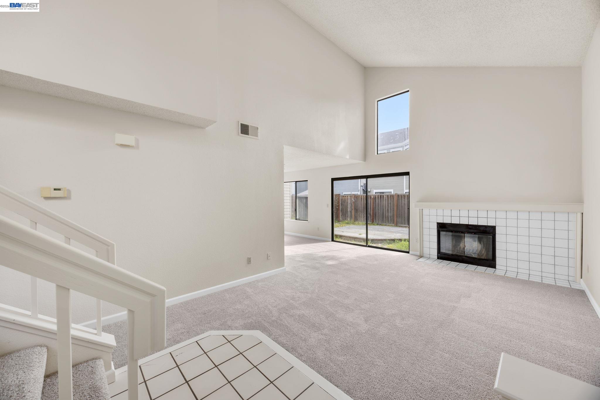 1068 Foster Street Alameda, CA 94502 - Photo 15 of 17 a view of an empty room with a fireplace and a window