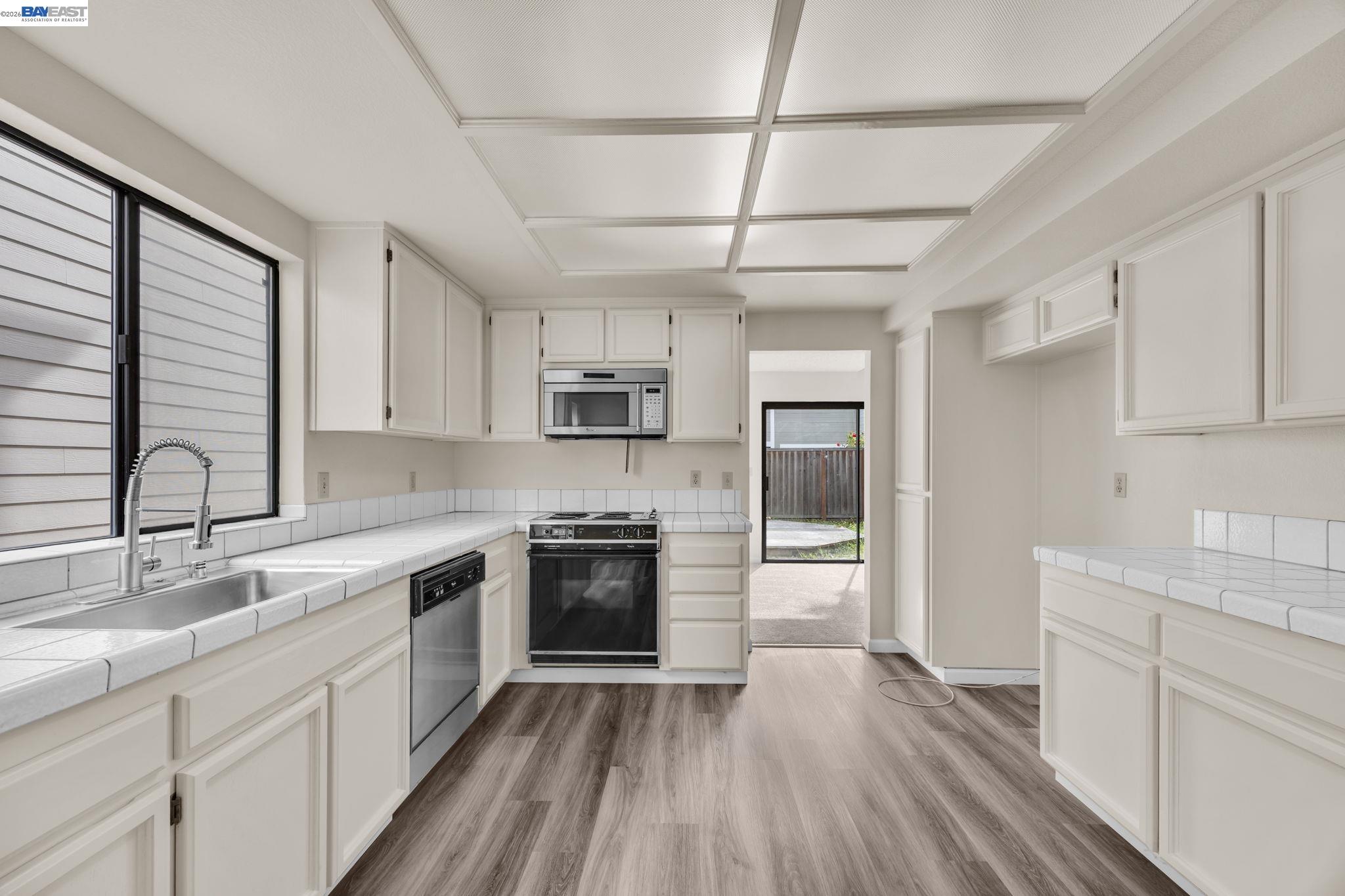 1068 Foster Street Alameda, CA 94502 - Photo 17 of 17 a kitchen with stainless steel appliances granite countertop hardwood floor sink stove and refrigerator