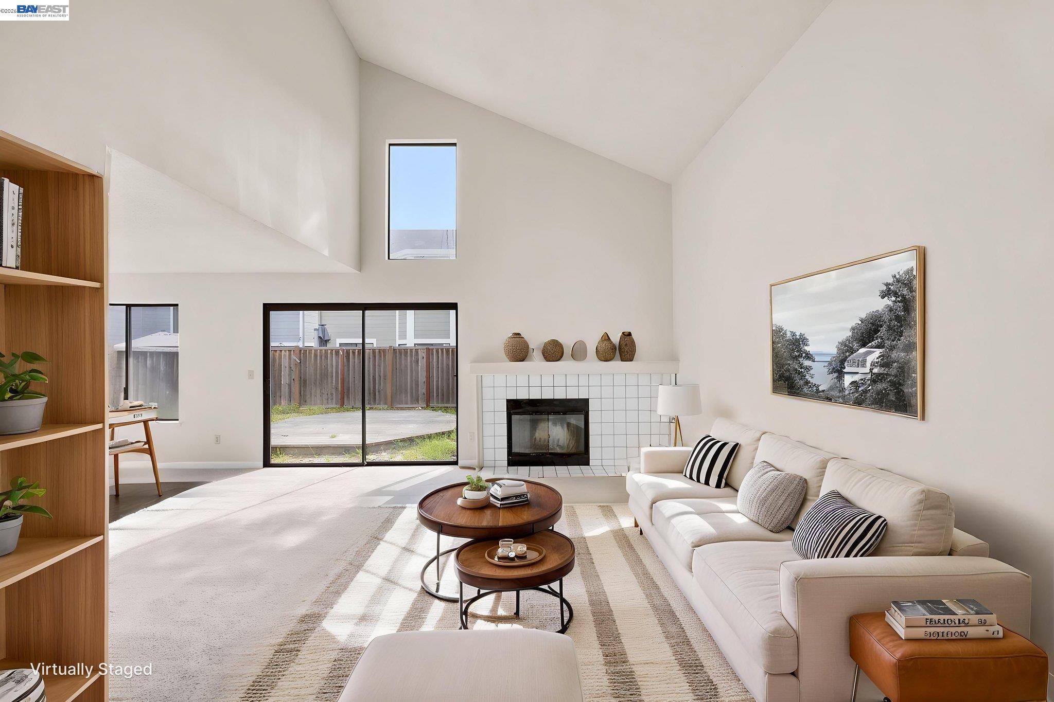 1068 Foster Street Alameda, CA 94502 - Photo 3 of 17 a living room with furniture a fireplace and a floor to ceiling window