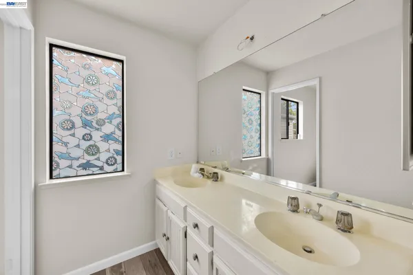 a bathroom with 2 sink and a mirror