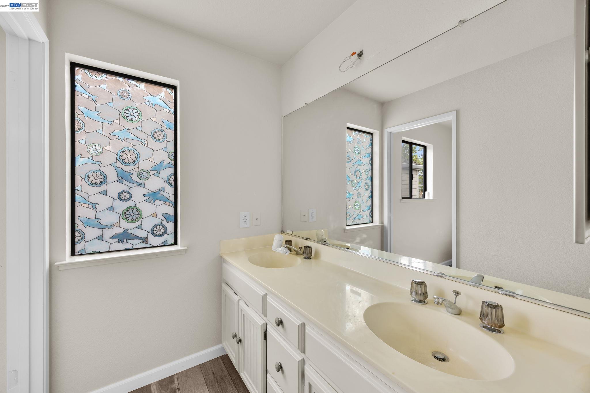 1068 Foster Street Alameda, CA 94502 - Photo 8 of 17 a bathroom with 2 sink and a mirror