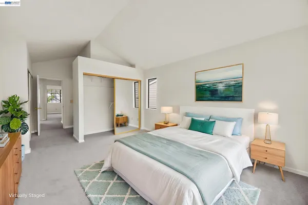 a bedroom with a bed and a couch