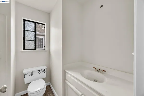 a white toilet sitting next to a bathroom sink