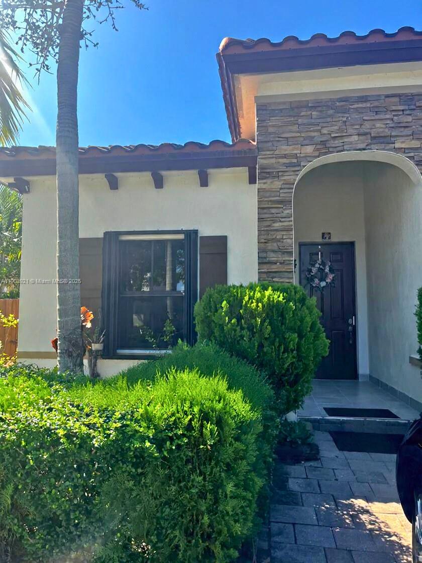 a front view of a house with a garden