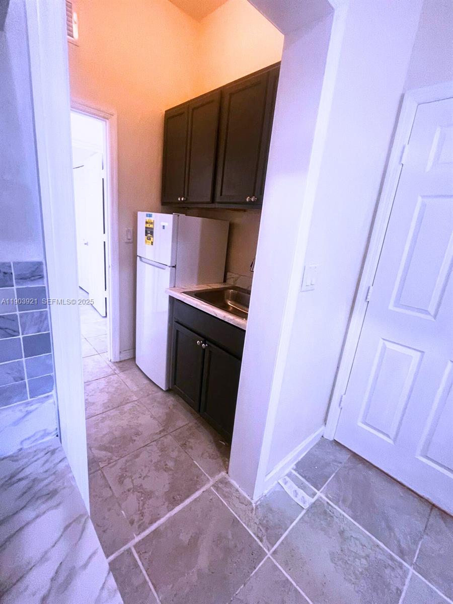116 Northeast 25th Terrace Homestead, FL 33033 - Photo 6 of 9 a kitchen with a sink and a stove top oven