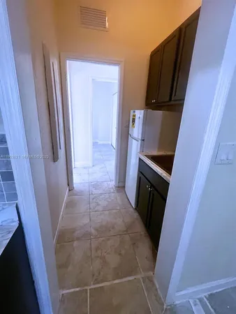 a view of a kitchen from refrigerator