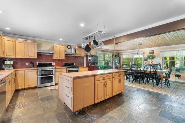 a kitchen with stainless steel appliances granite countertop a stove and a sink