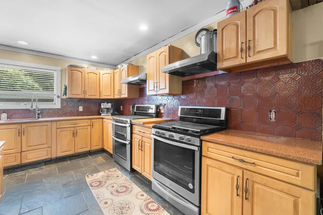 a bedroom with a bed and large windows