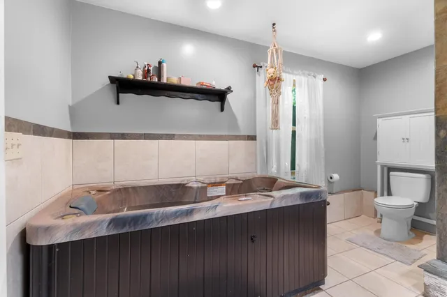 a en suite bathroom with a double vanity sink and a mirror