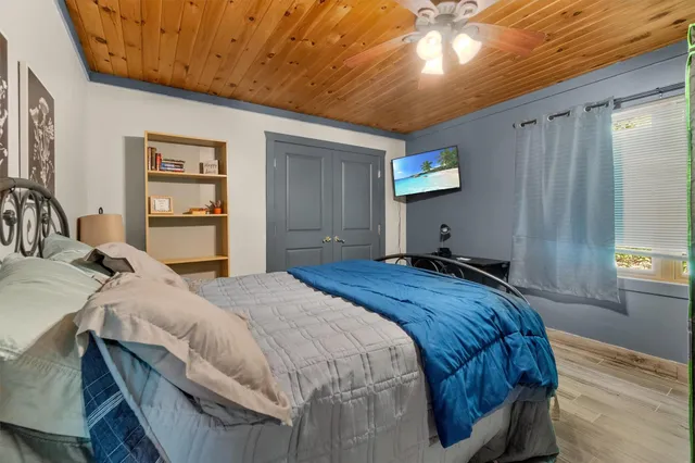 a bedroom with a bed and a chandelier