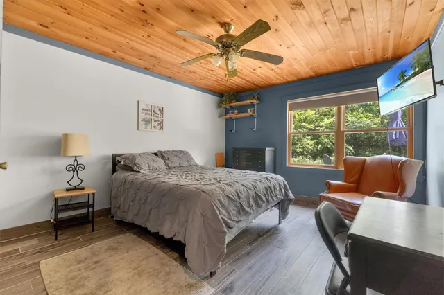 a bedroom with a bed and a chandelier