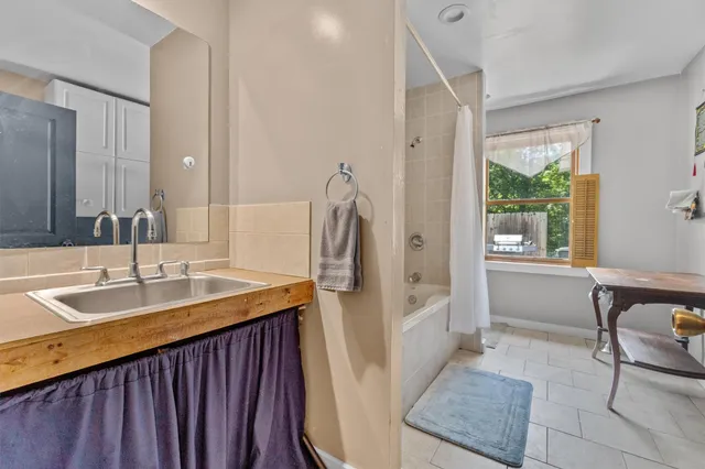 a bathroom with a bathtub and shower