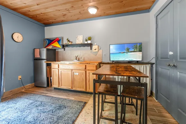 a living room with furniture a flat screen tv and a large window