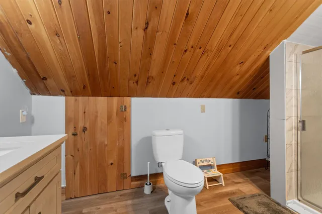 a view of a backyard with a patio and wooden fence