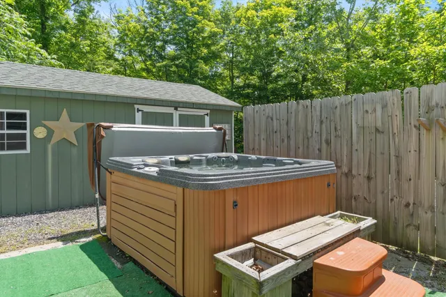 a view of a patio with table and chairs with wooden fence and plants