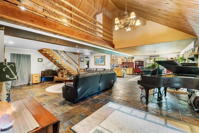 a view of a patio with table and chairs potted plants with wooden floor and fence