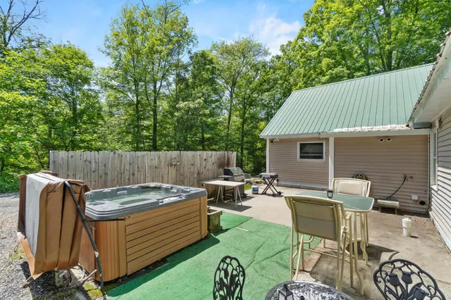 a view of a backyard with table and chairs and potted plants