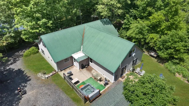 a view of a lake in between two large trees