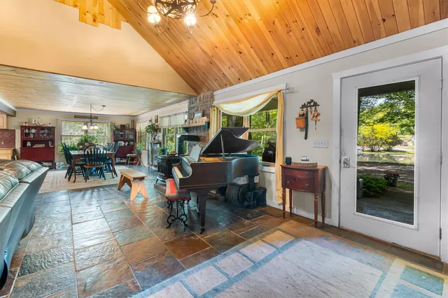 a living room with furniture a rug and a large window