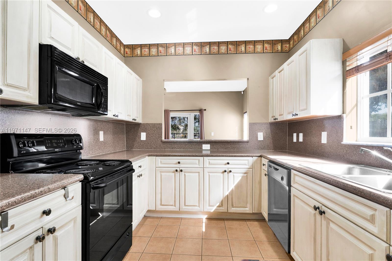 2875 Northeast 4th Street Homestead, FL 33033 - Photo 12 of 53 a kitchen with stainless steel appliances granite countertop a sink and a stove