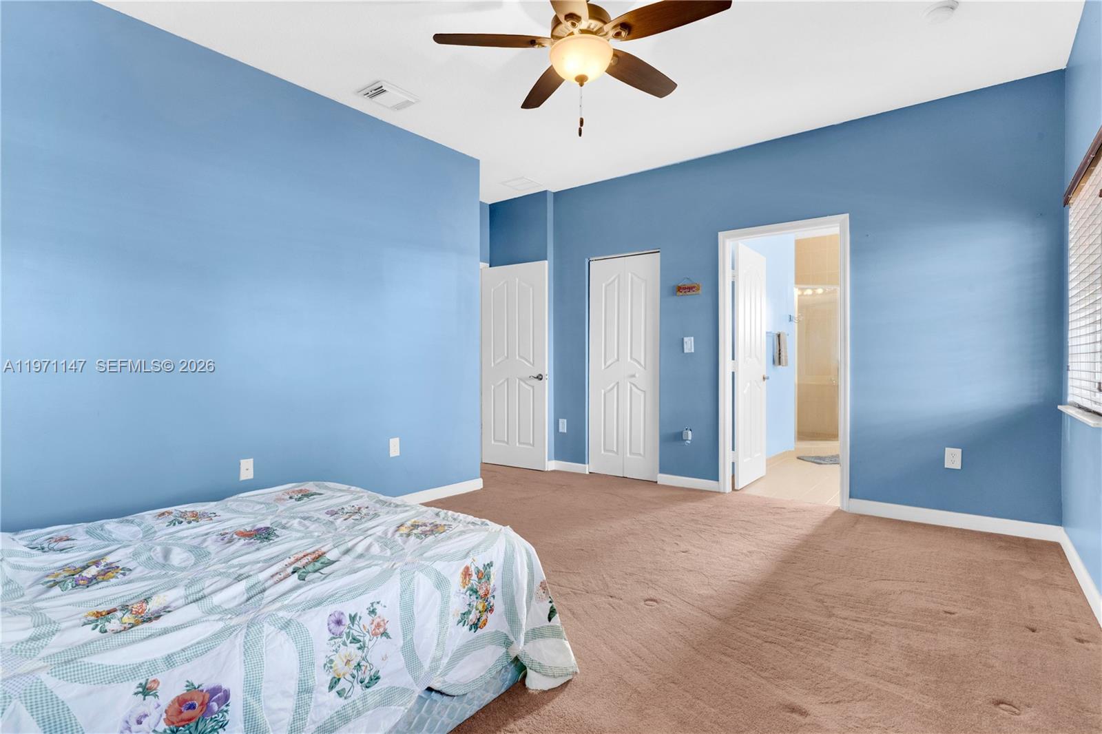 2875 Northeast 4th Street Homestead, FL 33033 - Photo 19 of 53 a bedroom with a large bed and a chandelier